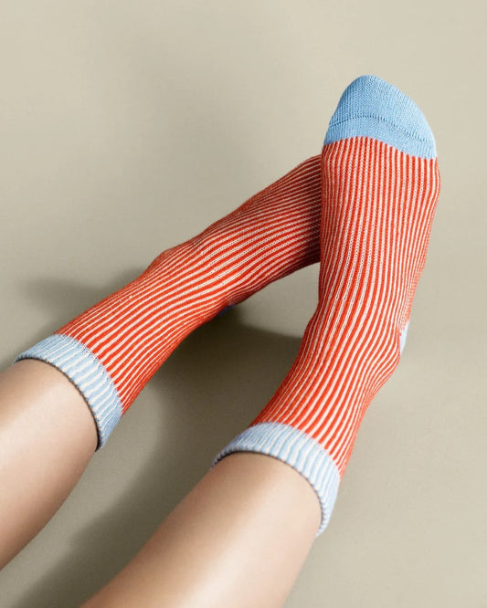 Persimmon umbrella crew sock from Hansel from Basel. Poppy red and pale ice blue. At  Clad, a sustainable clothing boutique in Asheville, NC