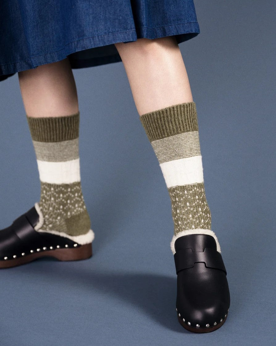 Olive Louie wool crew sock from Hansel from Basel. Paired with fur-lined black clogs and a denim skirt.