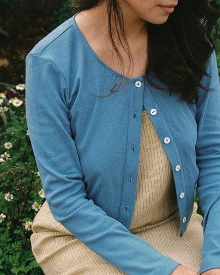 Medium blue robin's egg button-down long sleeve cardigan. Cropped and paired with a beige knit dress