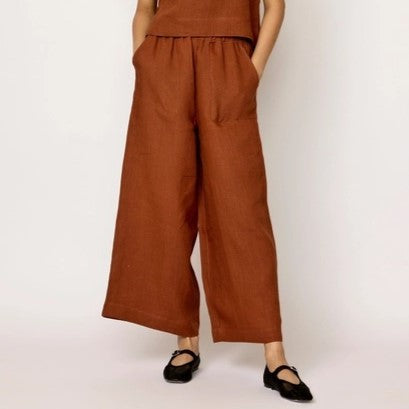 Every Pants by LAUDE the Label in an amber terracotta hue. Wide leg linen trousers with an elastic waist band. Paired with black flats.