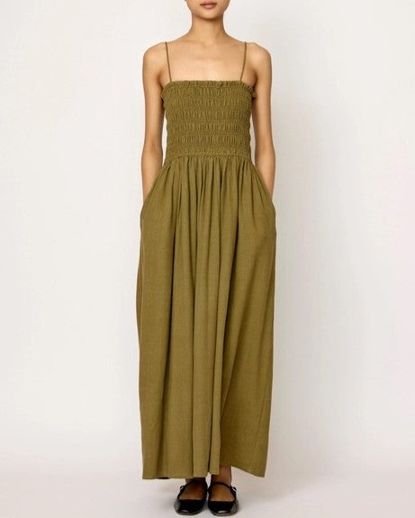 Spaghetti strap olive branch green smocked bodice midi dress by LAUDE the Label. Paired with black flats.