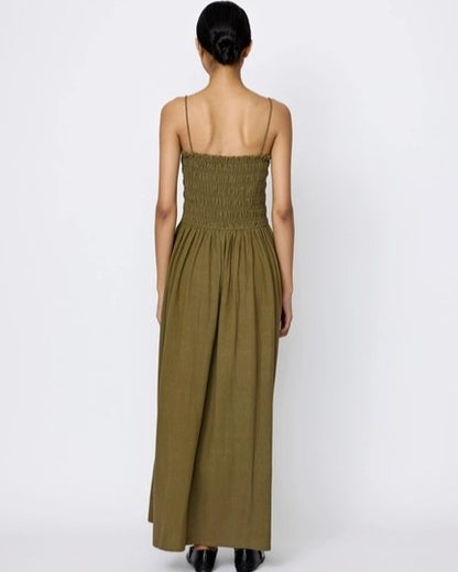 Spaghetti strap olive branch green smocked bodice midi dress by LAUDE the Label. Paired with black flats.