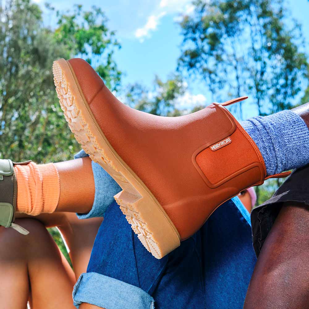 Rust terracotta Bobbi Rain Boot by Merry People at Clad, a sustainable clothing boutique in Asheville, NC.