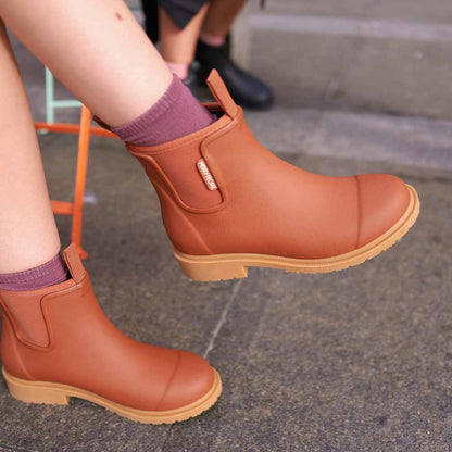 Rust terracotta Bobbi Rain Boot by Merry People at Clad, a sustainable clothing boutique in Asheville, North Carolina.