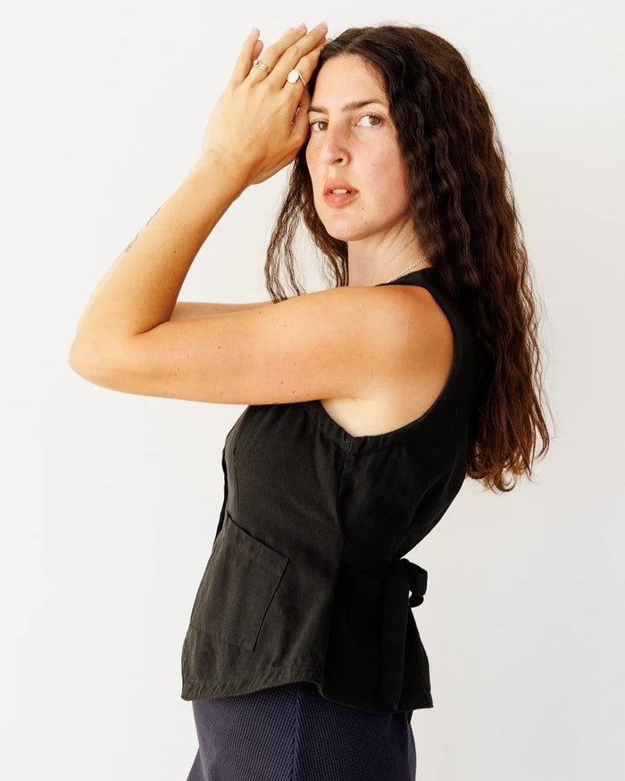 Noble button-down flared vest with front pockets and a tie back