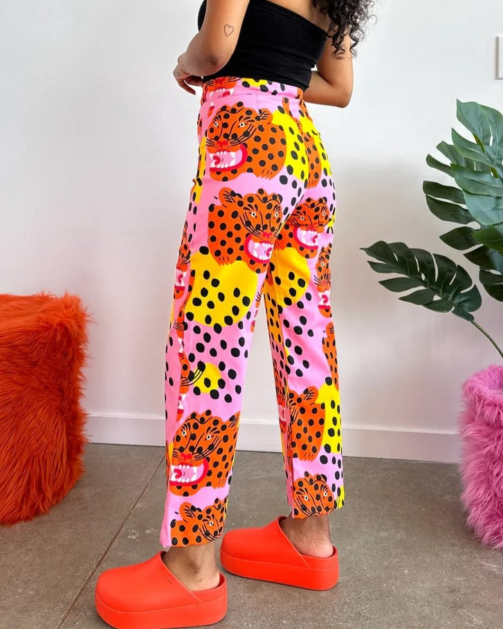 Micotti Cat orange, yellow, pink, and black polka dot bell bottom pants with a high waist. Made by Nooworks in California. Paired with chunky orange clogs and a fitted black top. 