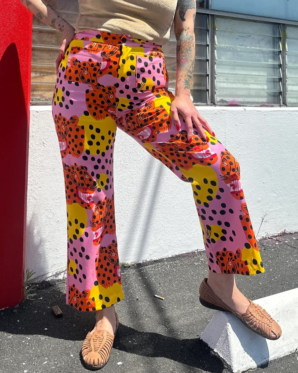 Micotti Cat orange, yellow, pink, and black polka dot bell bottom pants with a high waist. Made by Nooworks in California. Paired with woven flats and a velvet suede tan top. 