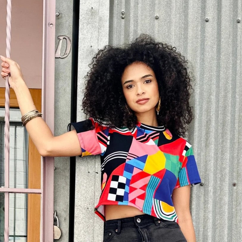 Crop top tee by Nooworks in Ansley new print. Crew neck with bold abstract shapes in red, pink, yellow, blule, black.