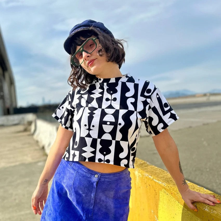 Noooworks crop top in black and white illusions print with a bright blue skirt