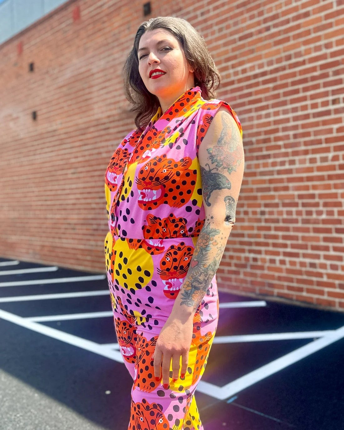 Pink, yellow, and orange tiger Micotti cat print Magic Jumpsuit by Nooworks. Button down closure front and a tapered ankle.