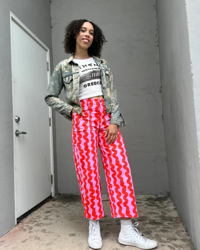 Nooworks pink squiggles skater pant paired with camo jacket and white sneakers