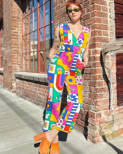 Nooworks Sonny Suit in Wormiverse, anabstract whimsical print with blue, green, yellow, pink, and red. Wrap style top with a wide leg and elastic waist at Clad, a sustainable clothing store in Asheville, NC