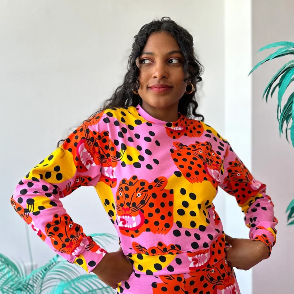 Stretchy long-sleeve track top made by Nooworks in California in Micotti Cat print. Orange, yellow, pink, and black polka dots. Paired with matching Micotti Cat Joggers.