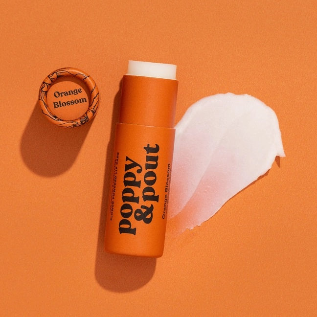 Poppy & Pout all-natural, cruelty-free lip balm in sweet orange blossom flavor. Orange recyclable tube.