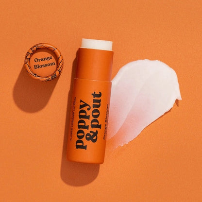 Poppy & Pout all-natural, cruelty-free lip balm in sweet orange blossom flavor. Orange recyclable tube.