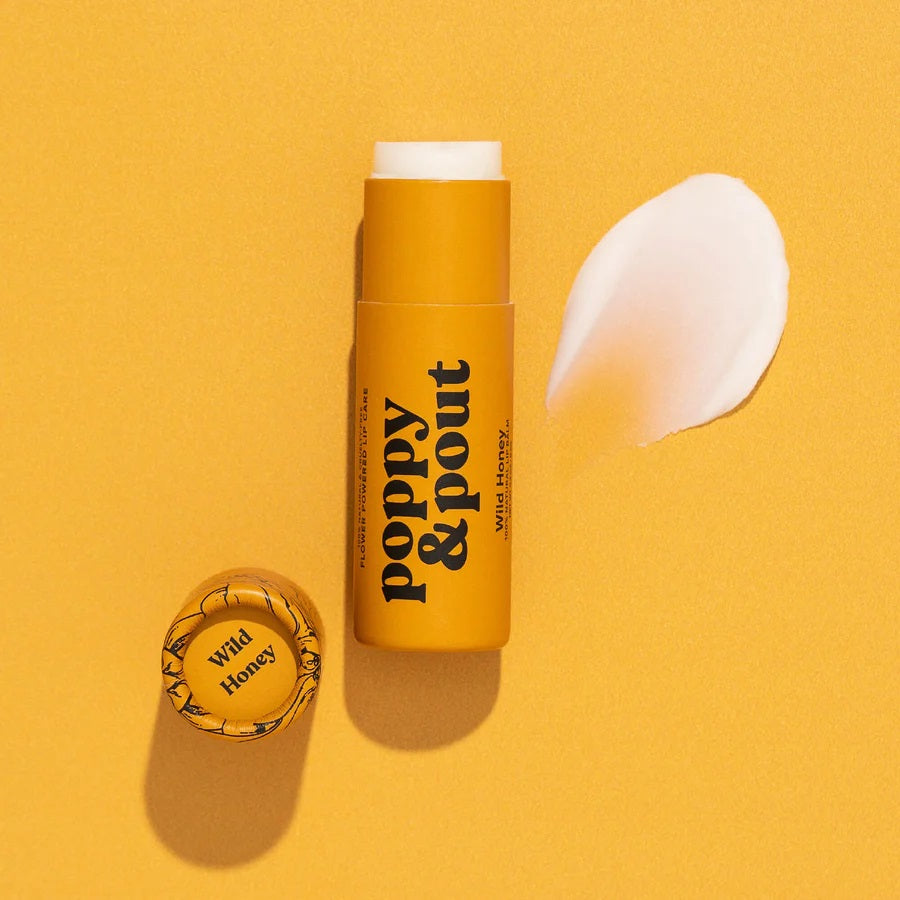 Poppy & Pout all-natural, cruelty-free lip balm in wild honey flavor. Yellow recyclable tube.