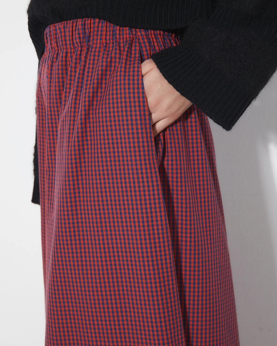 Checkered lobe pants from Rita Row paired with a black v-neck sweater and chestnut leather obots at Clad, a sustainable clothing shop in Asheville, NC.