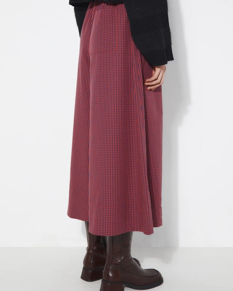 Checkered lobe pants from Rita Row paired with a black v-neck sweater and chestnut leather obots at Clad, a sustainable clothing shop in Asheville, NC.