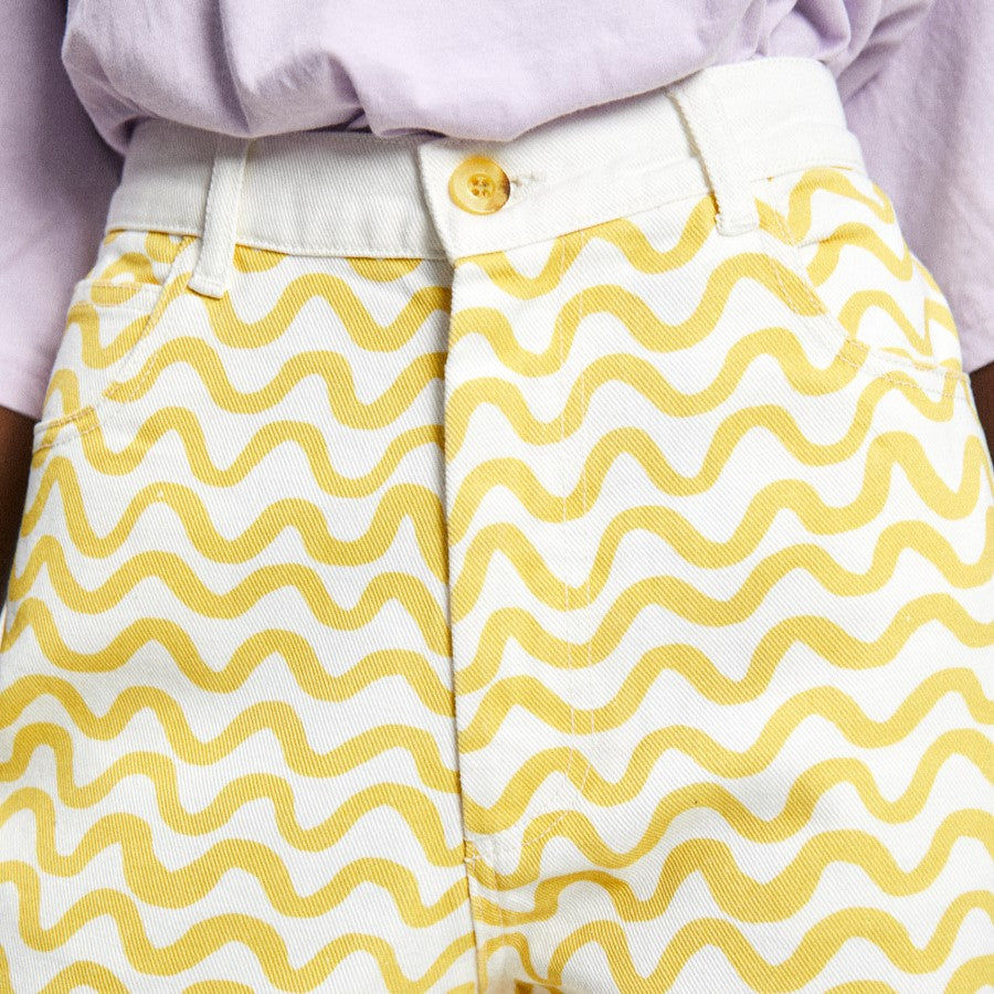 Luce yellow squiggle pattern print pant on white denim with a panel white back and a button and zip front closure.