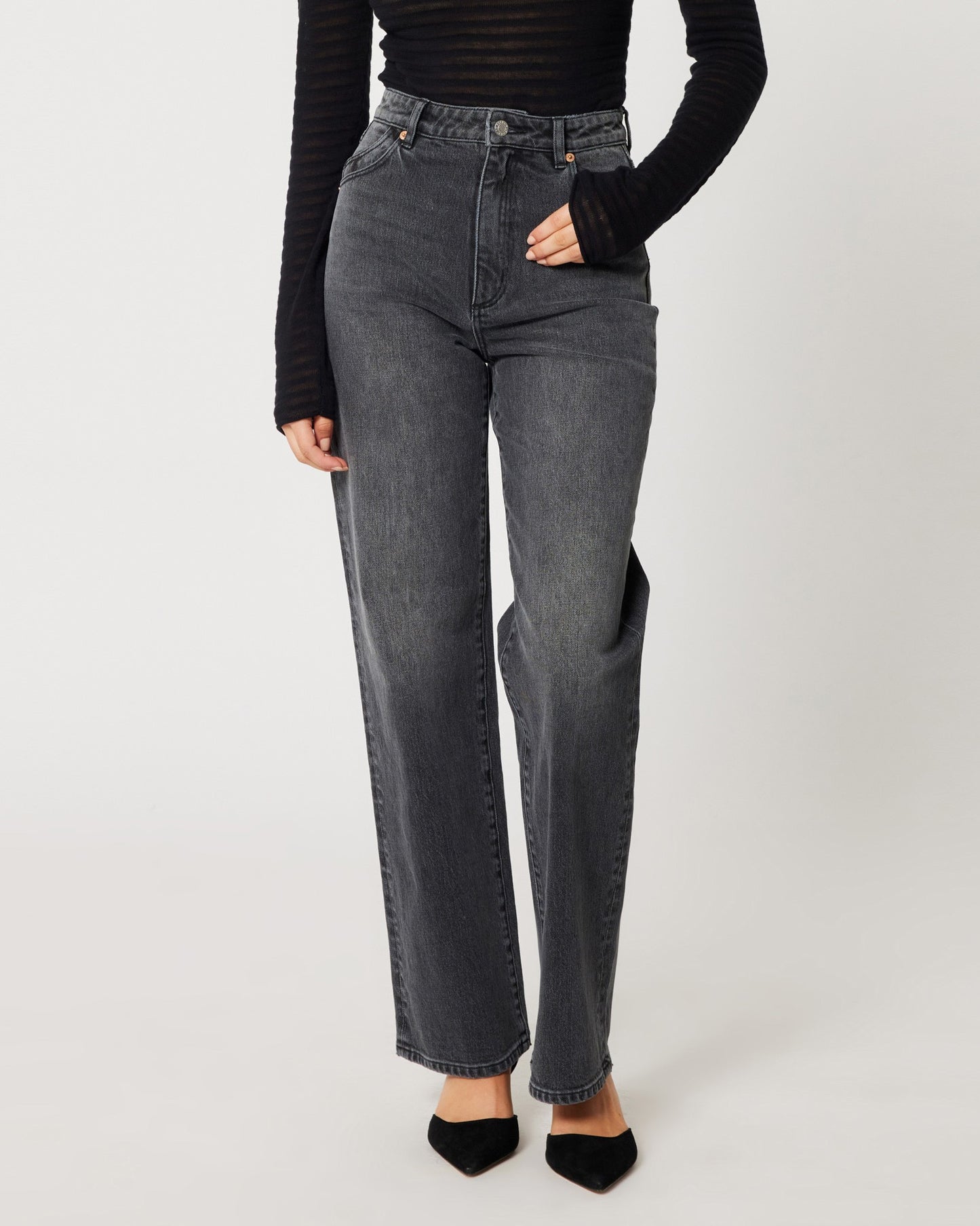 High rise worn black Heidi Jean from Rolla's. Paide with a mesh see-through long sleeve black top an black pumps.