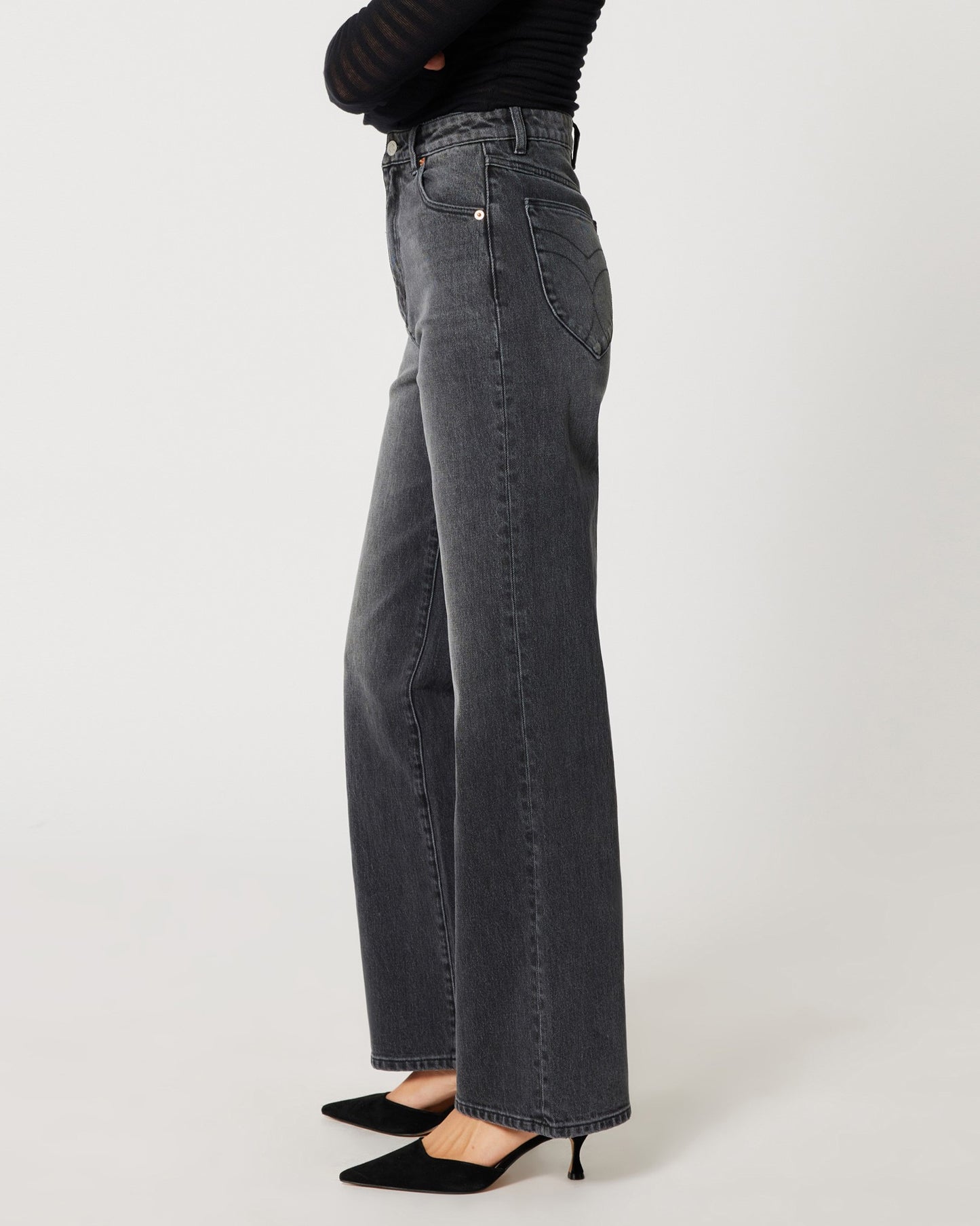 High rise worn black Heidi Jean from Rolla's. Paide with a mesh see-through long sleeve black top an black pumps.