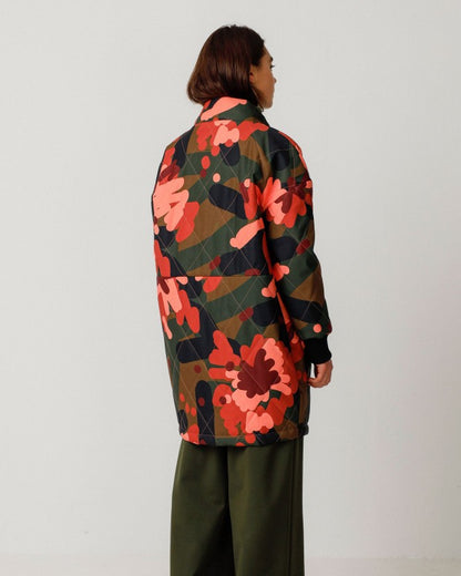 Abstract floral camo button-down jacket coat by SKFK. High mock neck collar and rib cuff sleeves. Paired with flowy wide leg olive hunter green linen pants.