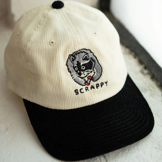 Scrappy raccoon white and black corduroy dad hat by Stay Home Club
