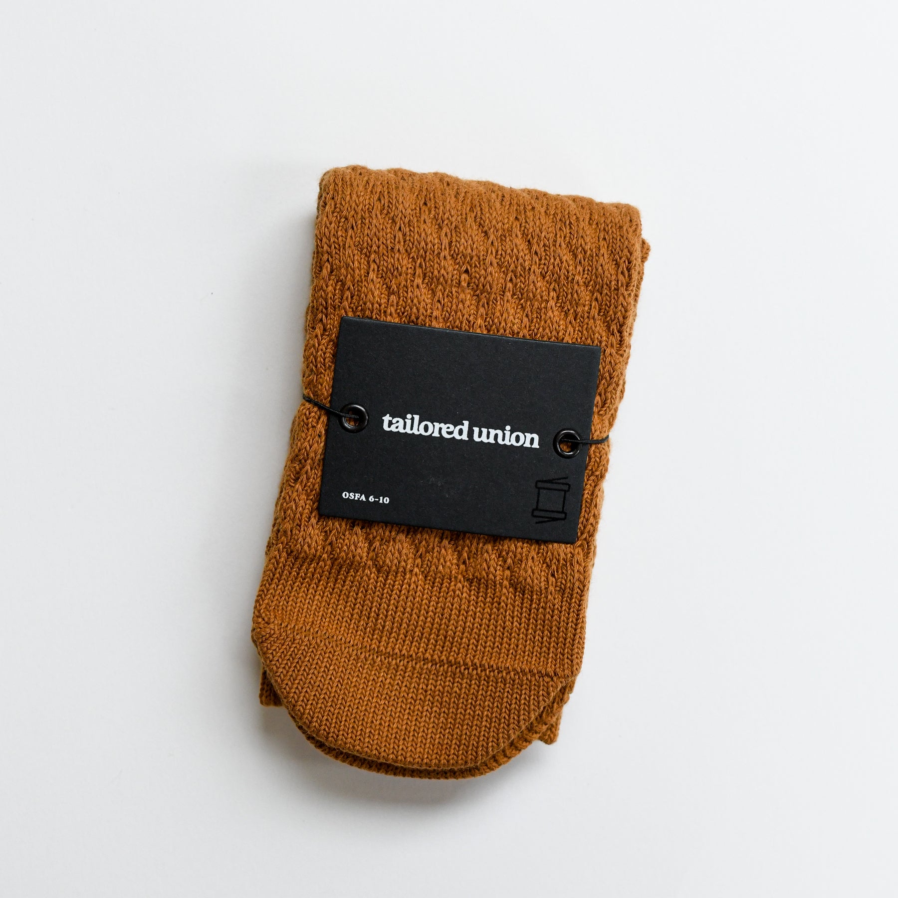 Eben knit ankle sock by Tailored Union in rust orange.