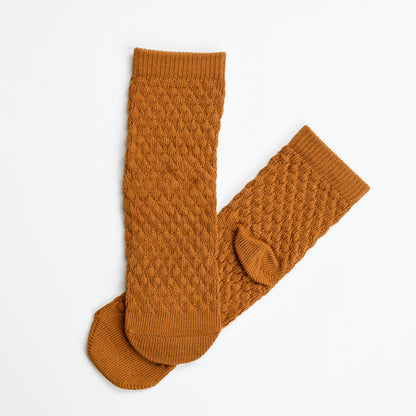 Eben knit ankle sock by Tailored Union in rust orange.