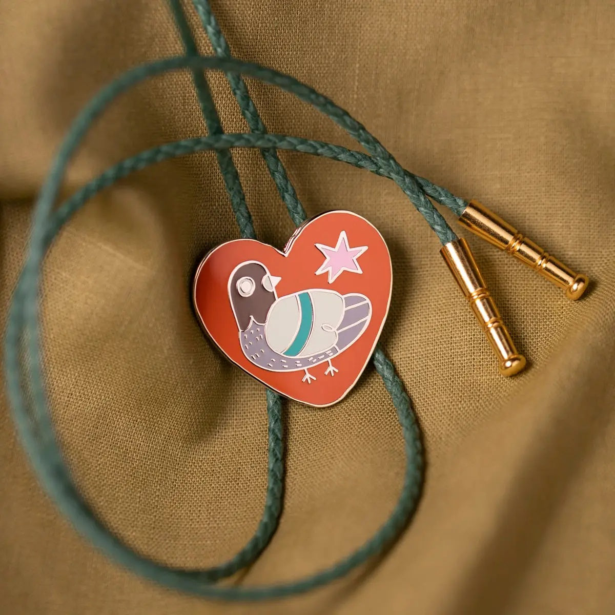 Pigeon bolo tie with vegan leather green cord