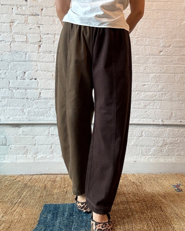 Verity & daughters espresso colorblock barrel pants with elastic waist, front seam, and alternating mismatched back pockets. Paired with leopard ballet flats