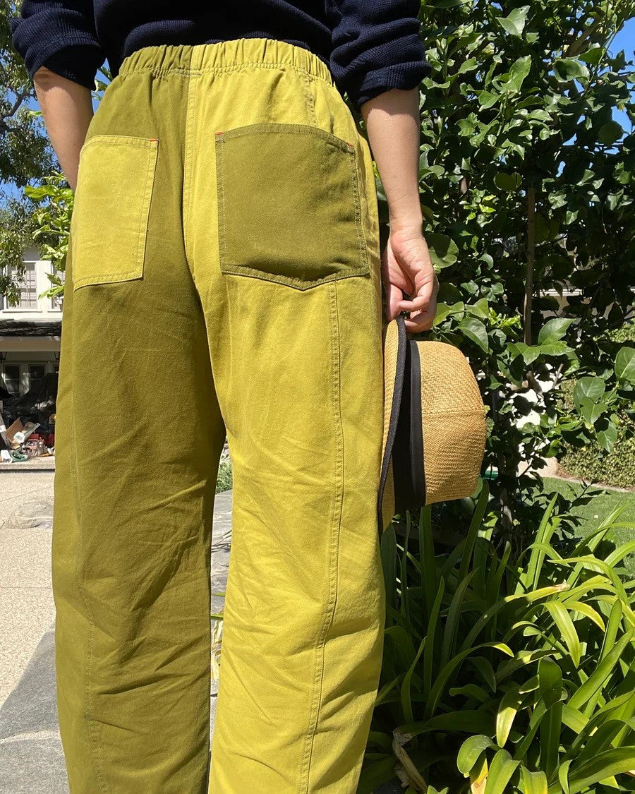 Colorblock lime green pants from Verity & Daughters with contrasting back pockets and an elastic waist at Clad, a sustainable clothing boutique in Asheville, NC