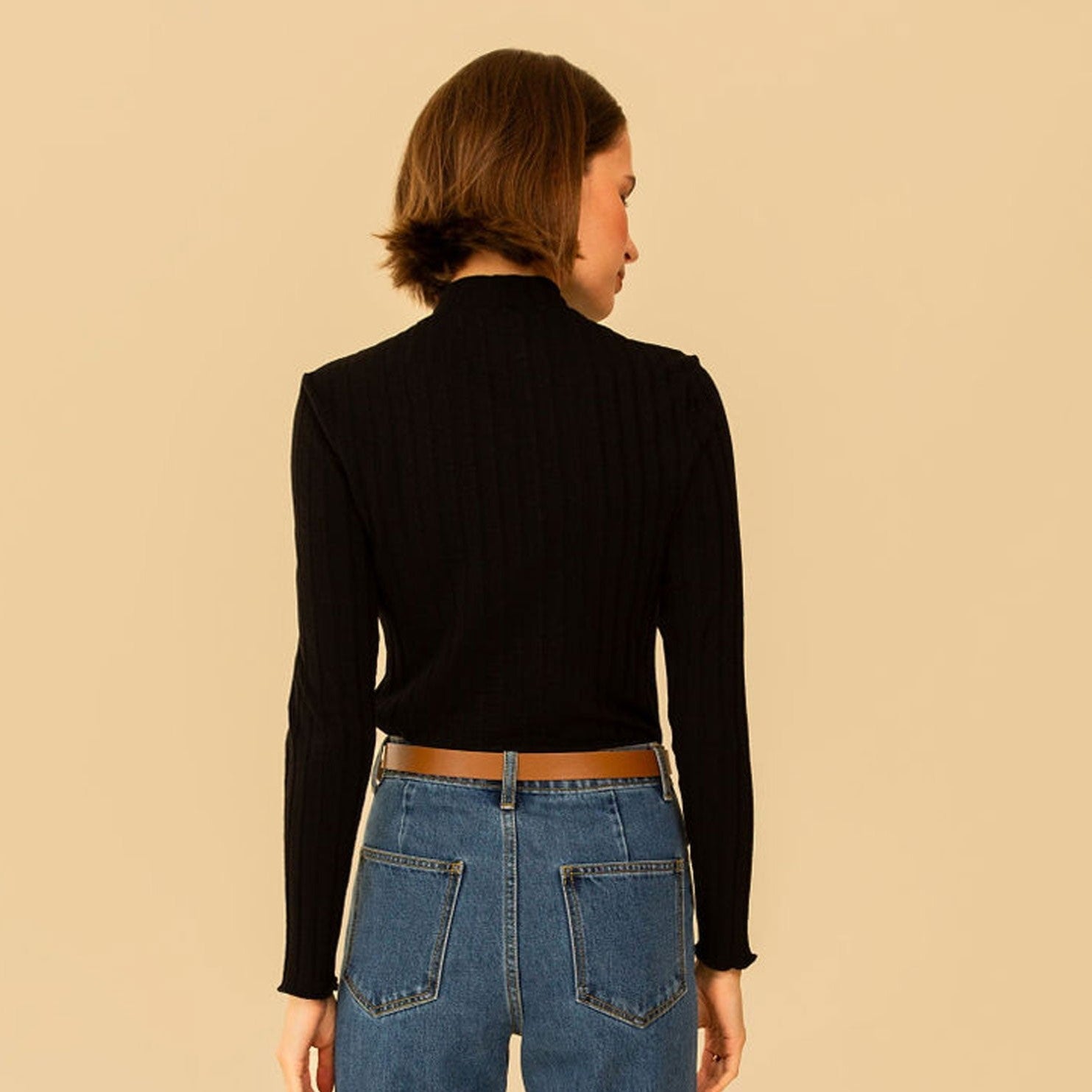 Mock neck long sleeve fitted Gigi Top by Whimsy & Row in black. Paired with denim and a cognac belt