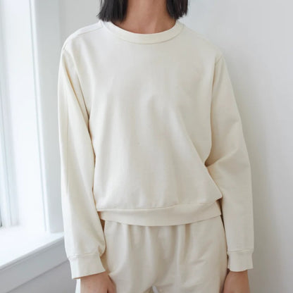 The Easy Summer Sweatshirt from sustainable brand Wol Hide in cotton with lightweight French terry. Wide hem, crew neck, white light natural beige cream hue.