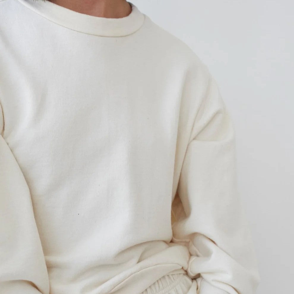 The Easy Summer Sweatshirt from sustainable brand Wol Hide in cotton with lightweight French terry. Wide hem, crew neck, white light natural beige cream hue.