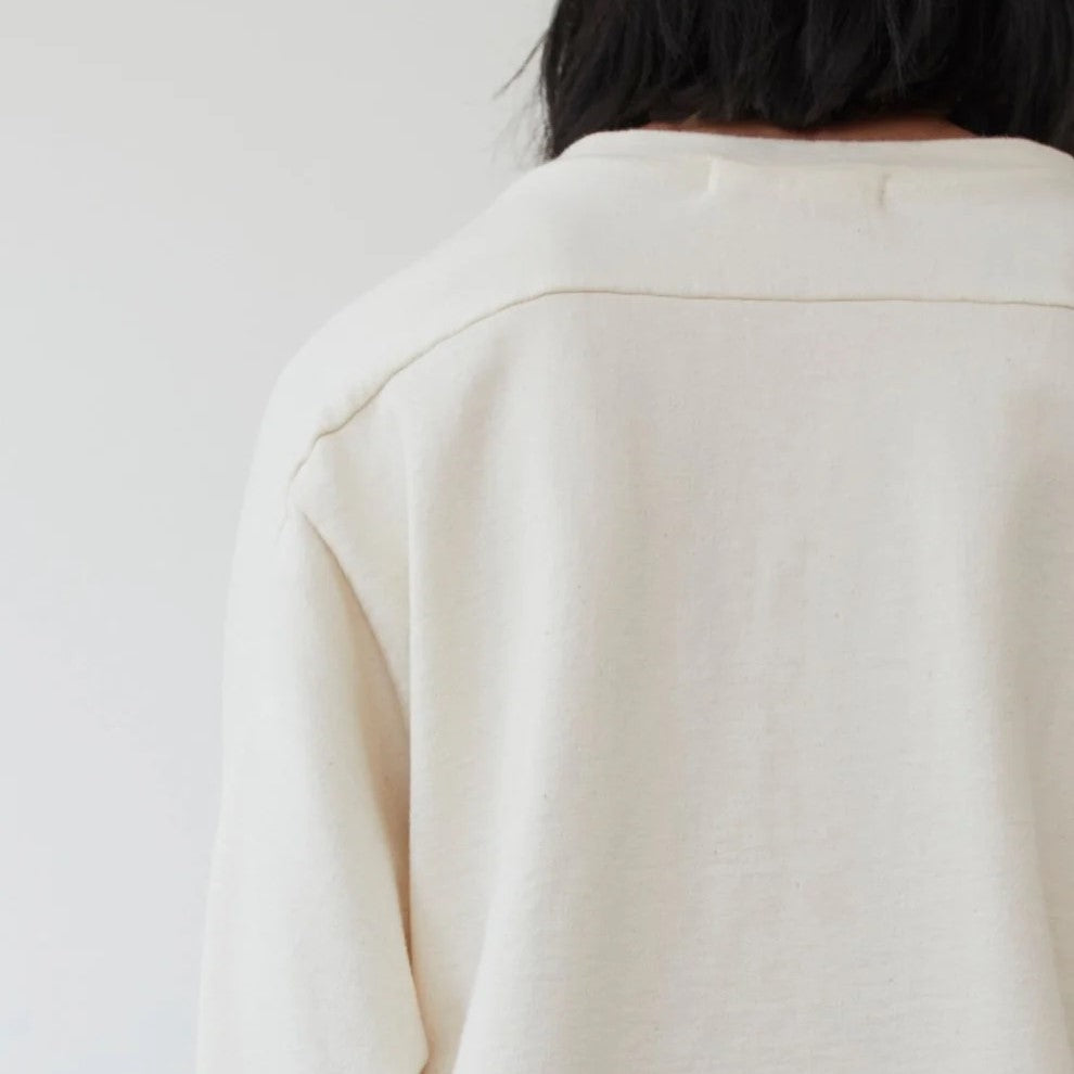 The Easy Summer Sweatshirt from sustainable brand Wol Hide in cotton with lightweight French terry. Wide hem, crew neck, white light natural beige cream hue.