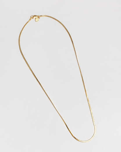 A thin herringbone gold chain necklace for everyday wear by Wolf Circus.